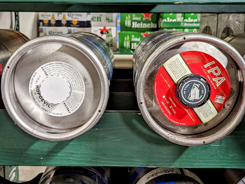 A rack of beer kegs on a shelf.