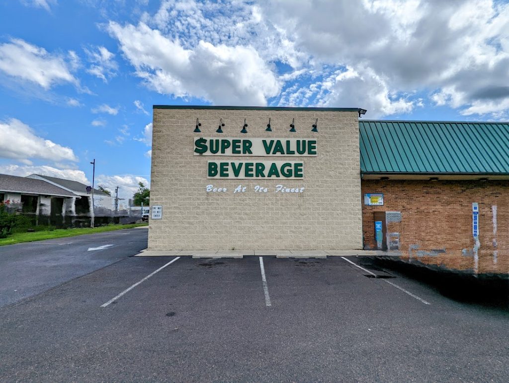 A building with a sign that says super value beverage.
