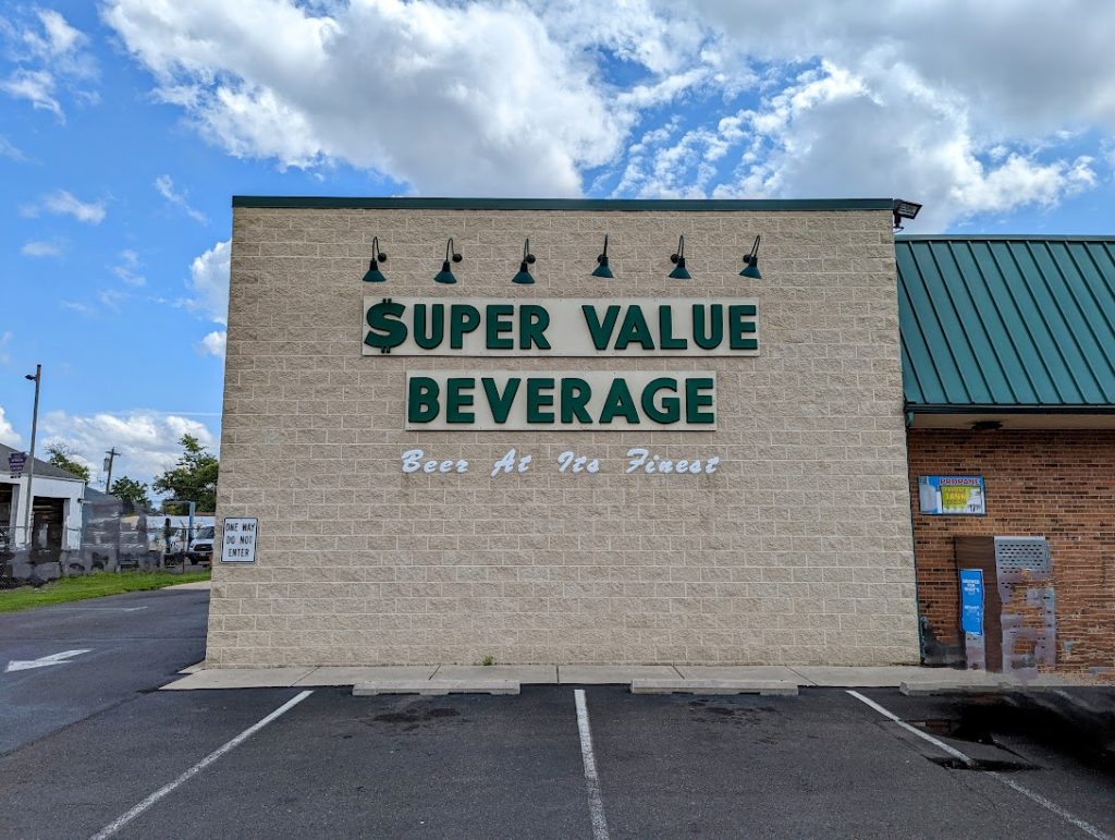 A building with a sign that says super value beverage.