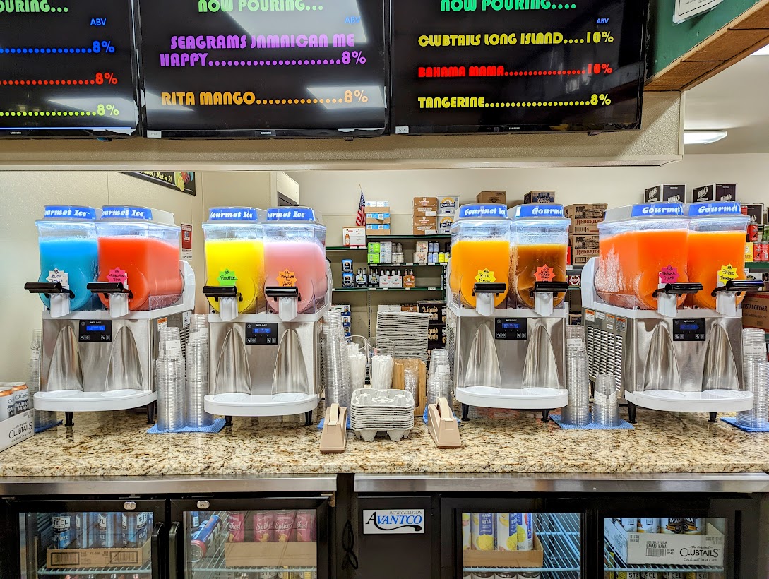 A counter with a variety of juices and sodas.
